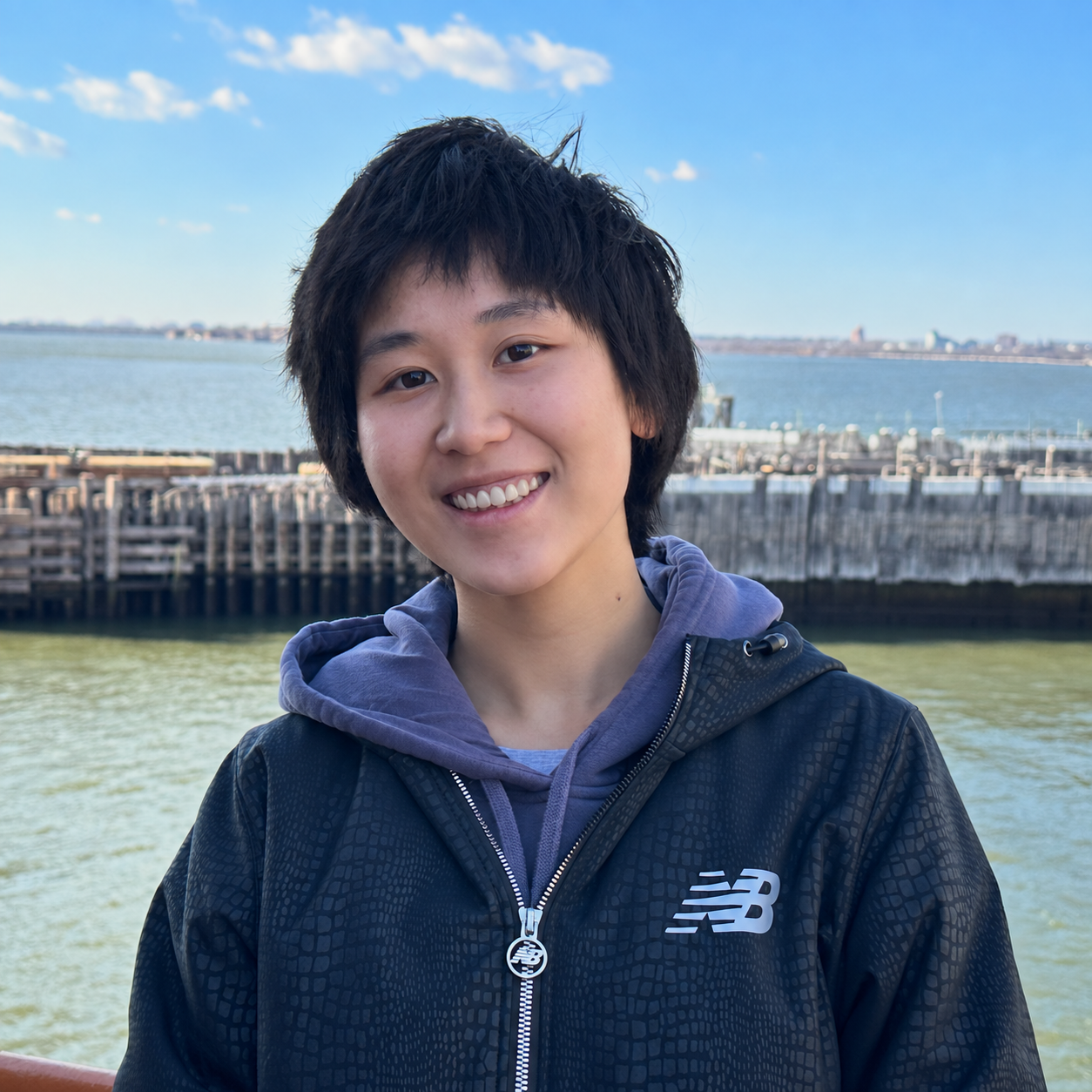 Ruiqi Lyu smiling by the waterfront